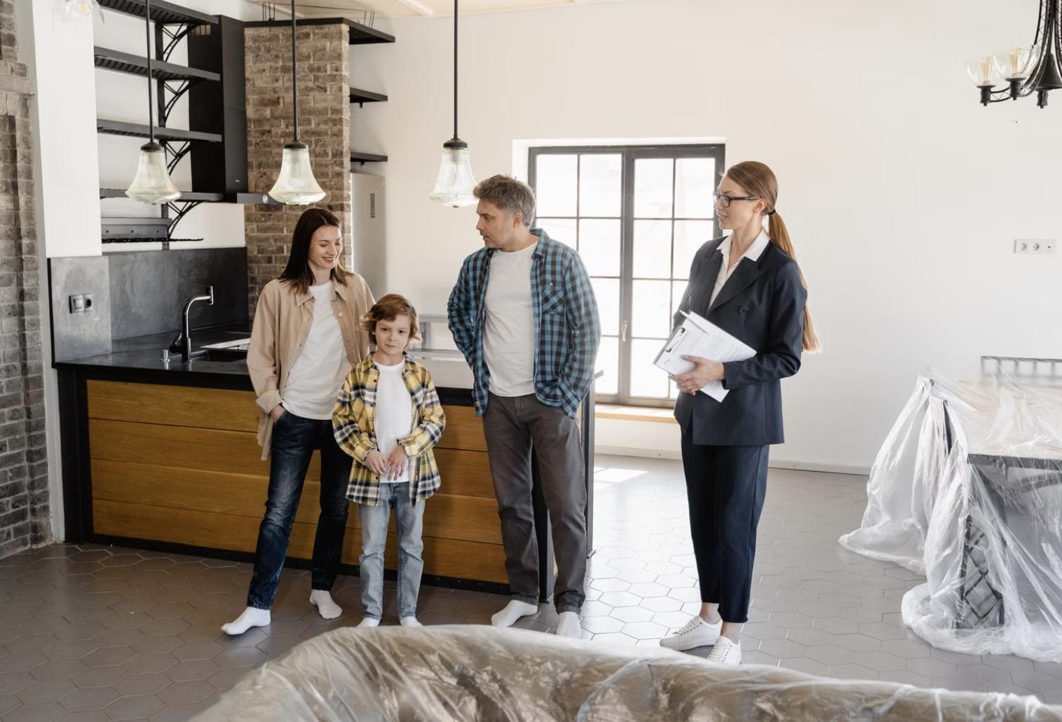 A REALTOR with a family standing in the kitchen of their home